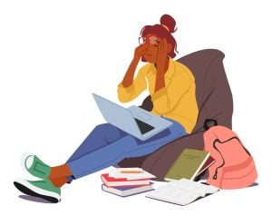 Illustration of an anxious student sat on a beanbag with books surrounding her, rubbing her eyes.