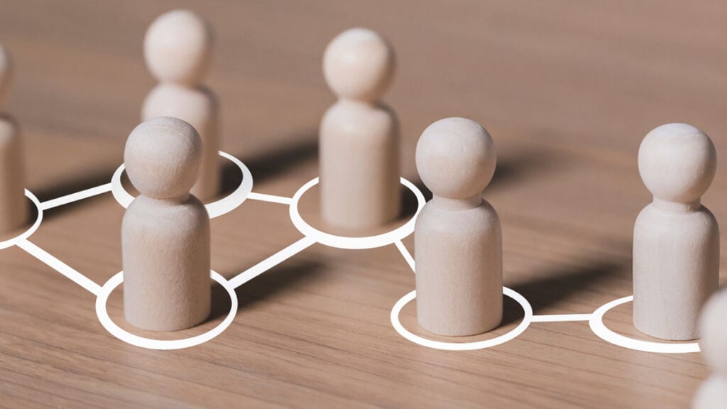 Social Control Theory of Crime 1 small wooden pins in the shape of people connected by white lines.